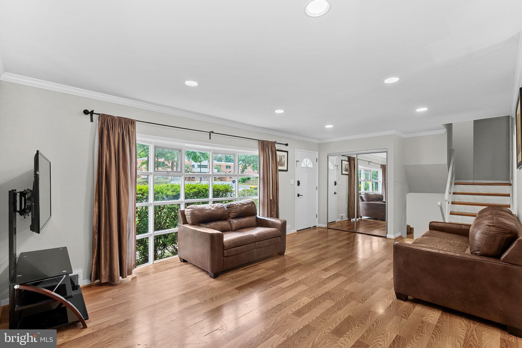 6313 Bardu Avenue Springfield, VA 22152 - Photo 6 of 26 a living room with furniture window and a flat screen tv