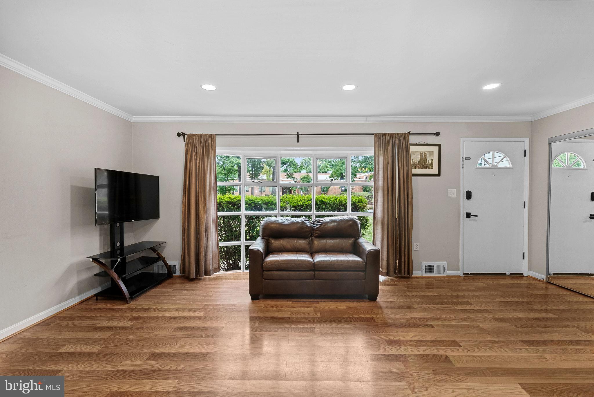 6313 Bardu Avenue Springfield, VA 22152 - Photo 7 of 26 a living room with furniture and a flat screen tv