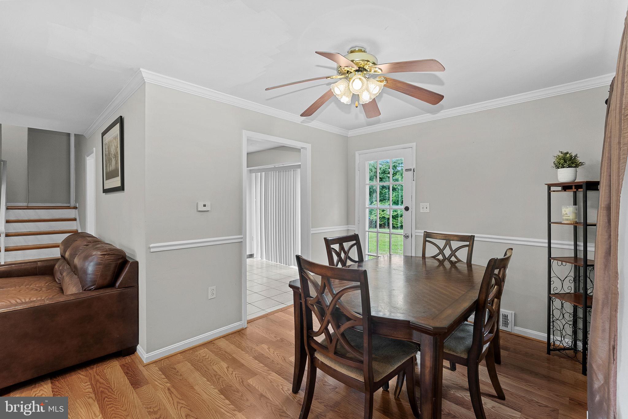 6313 Bardu Avenue Springfield, VA 22152 - Photo 9 of 26 a view of a dining room with furniture and wooden floor