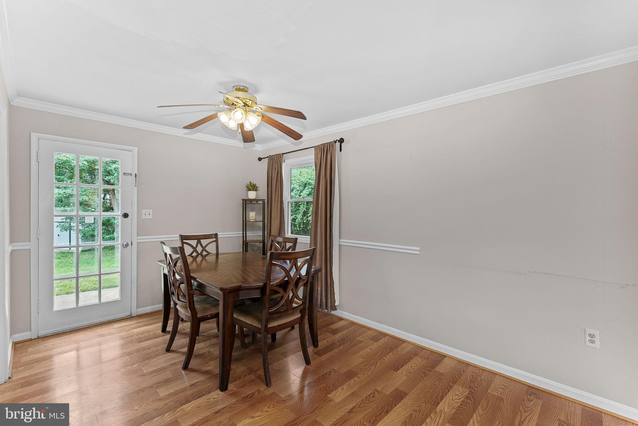 6313 Bardu Avenue Springfield, VA 22152 - Photo 10 of 26 a view of a dining room with furniture window and wooden floor