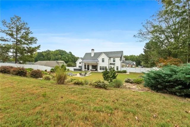 a kitchen with a sink a stove and chairs