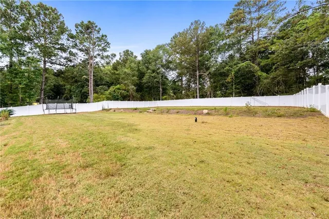 a kitchen with kitchen island granite countertop a sink a center island stainless steel appliances and cabinets