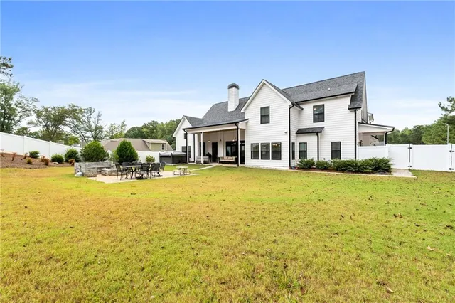 a large kitchen with a table and chairs