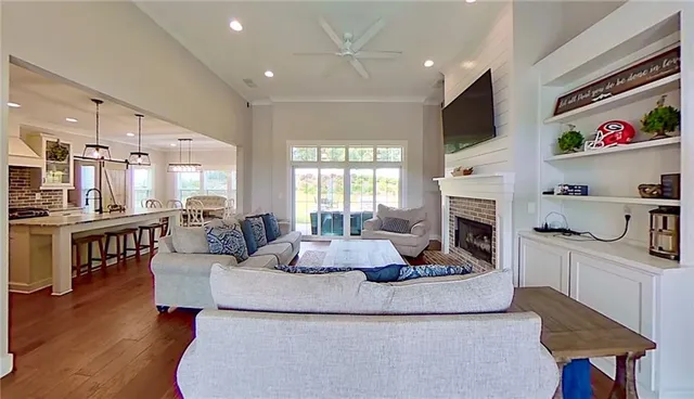 a view of a kitchen with wooden floor and electronic appliances