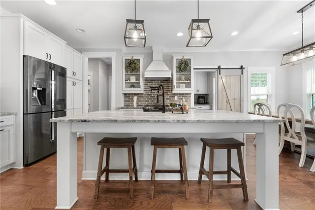 a bathroom with a granite countertop sink toilet and mirror
