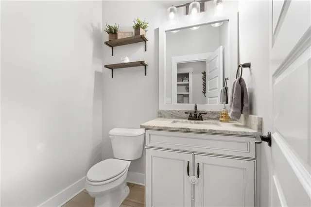 a bedroom with a bed a chandelier and dresser