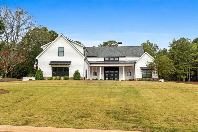a view of a patio with couches chairs and a big yard