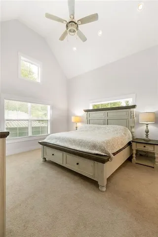 a bathroom with a granite countertop toilet a sink and a mirror