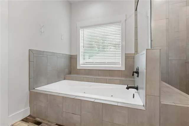 a aerial view of a house with swimming pool lawn chairs and a yard