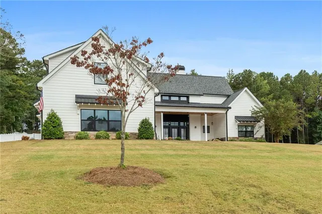 a view of a house with swimming pool and sitting area