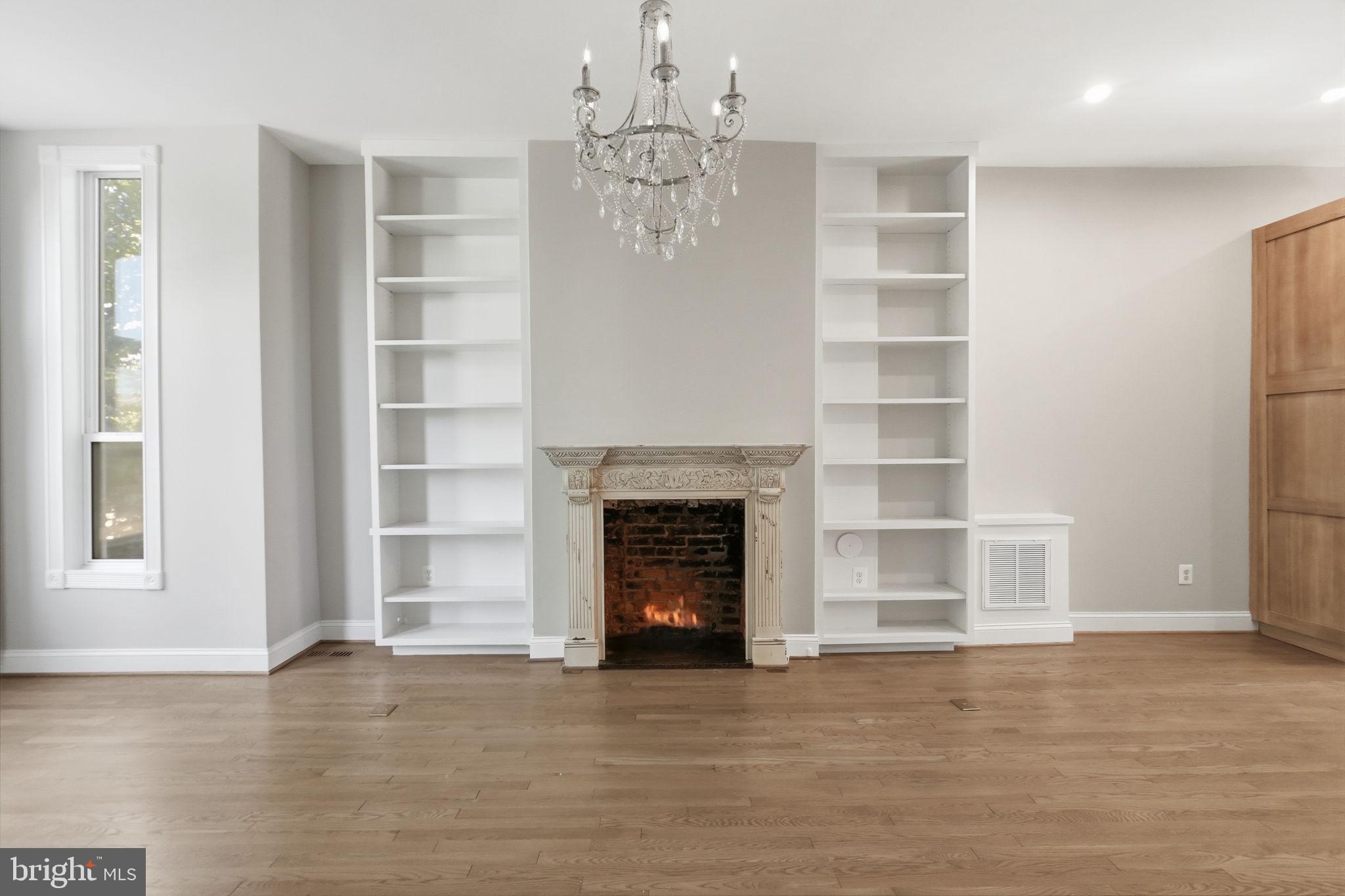 706 12th Street Northeast Washington, DC 20002 - Photo 5 of 49 a view of an empty room with a fireplace and a window