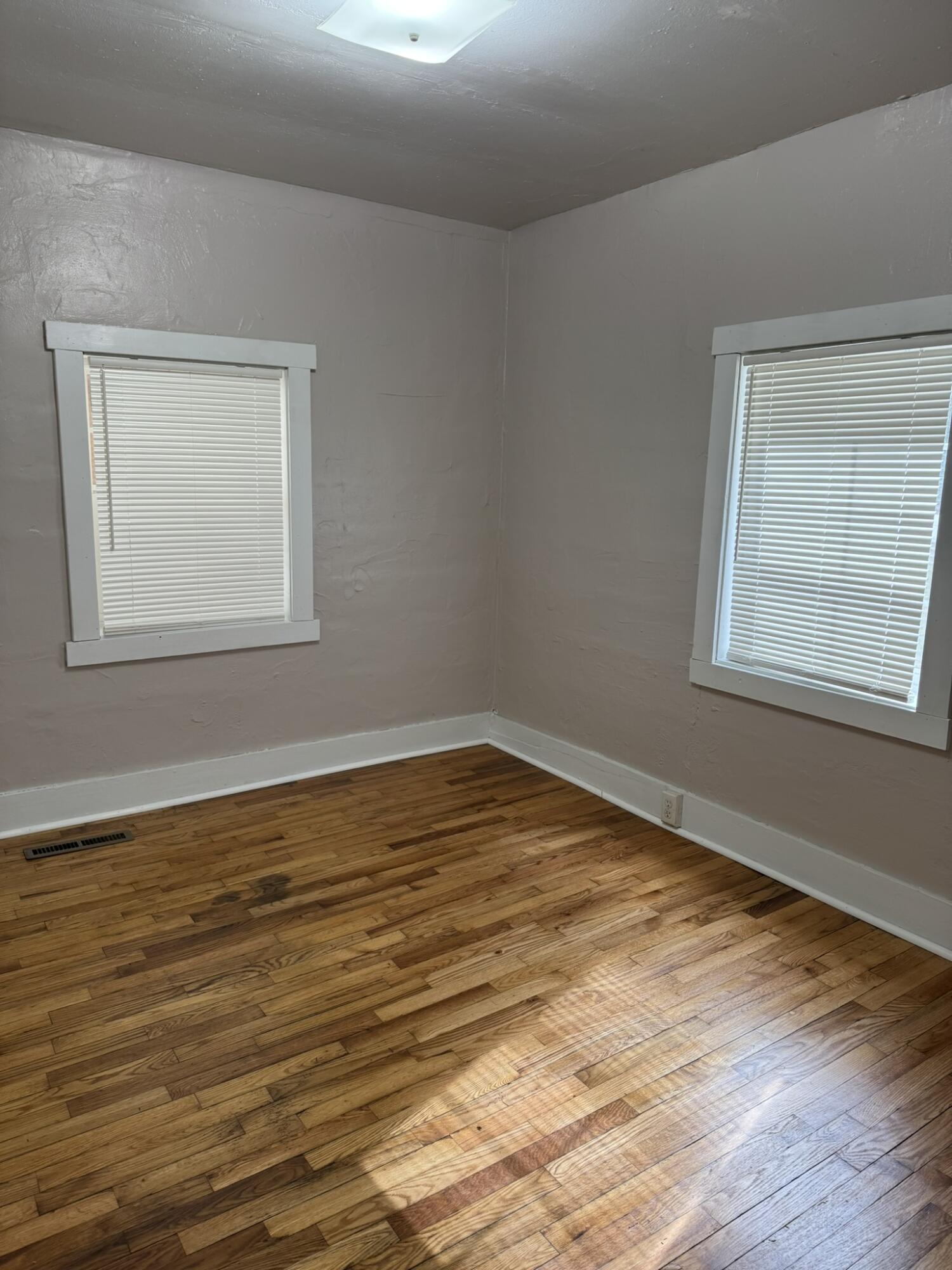 286 Ingramville Road Ferrum, VA 24088 - Photo 13 of 25 a view of an empty room with wooden floor and a window