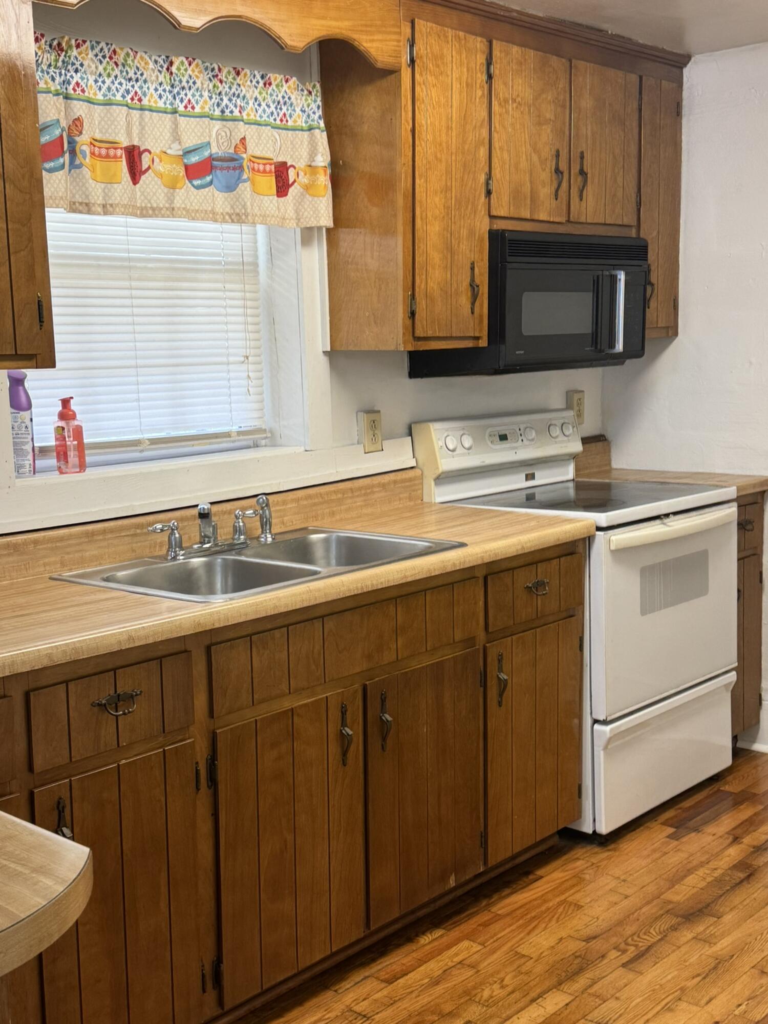 286 Ingramville Road Ferrum, VA 24088 - Photo 5 of 25 a kitchen with stainless steel appliances a sink dishwasher stove and microwave with wooden floor