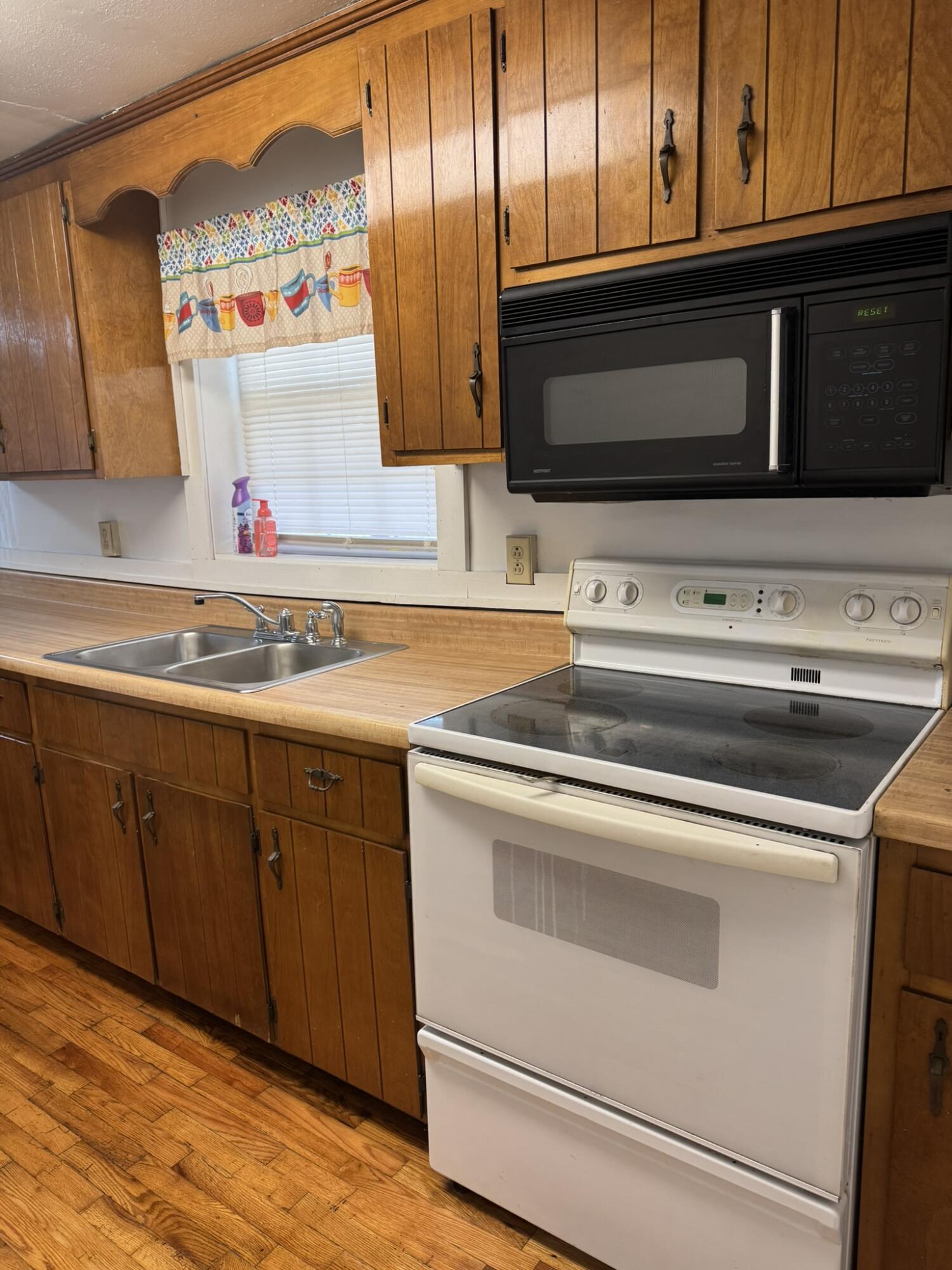 286 Ingramville Road Ferrum, VA 24088 - Photo 8 of 25 a utility room with stainless steel appliances granite countertop cabinets and a microwave oven