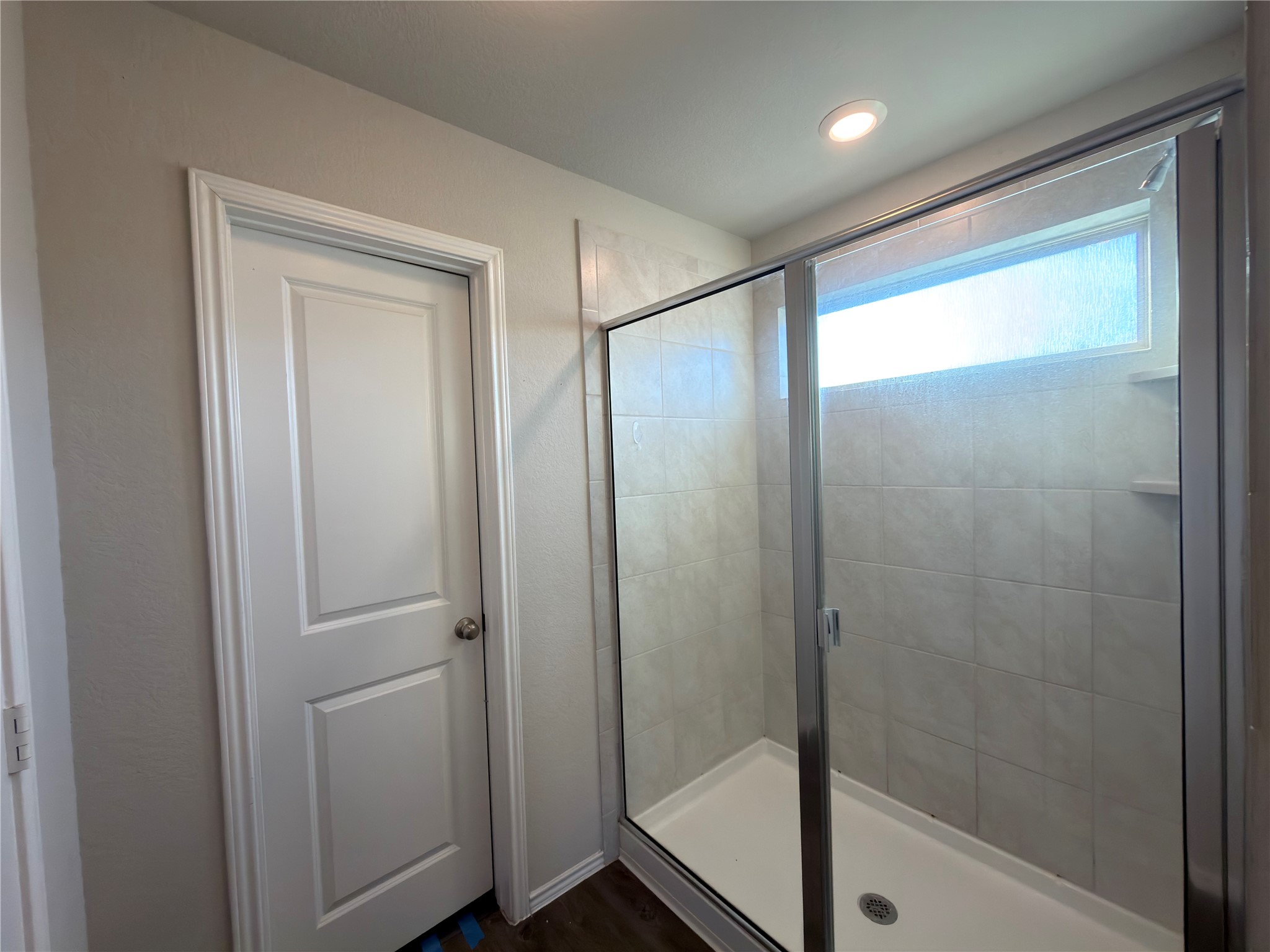21700 Urraca Lane Pflugerville, TX 78660 - Photo 16 of 40 Bathroom with a shower stall and dark wood finished floors