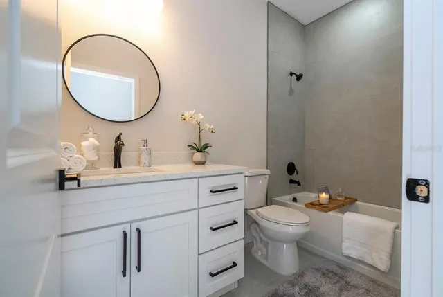 a bathroom with a toilet a sink and a mirror