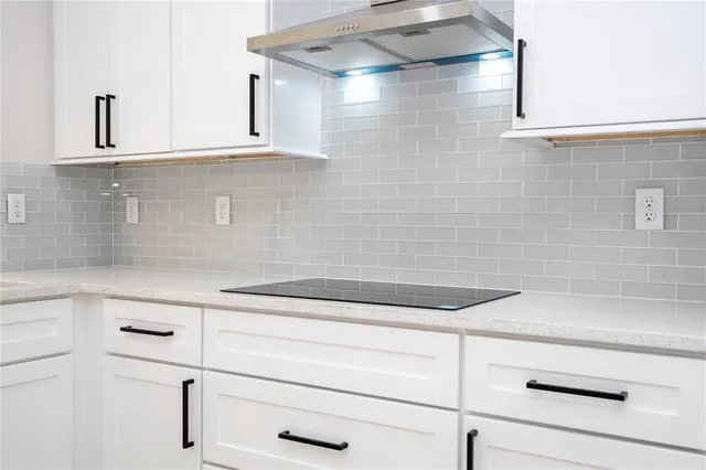a bathroom with a bathtub and cabinets