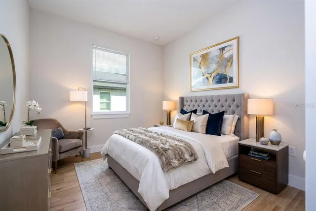 a bedroom with a bed and a lamp