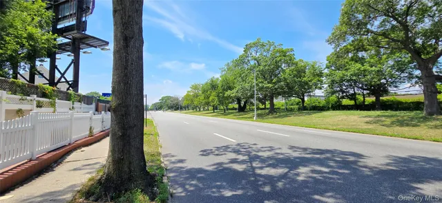 a view of a street with a building in the background