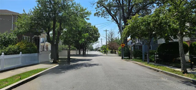 a view of a street with a building and trees