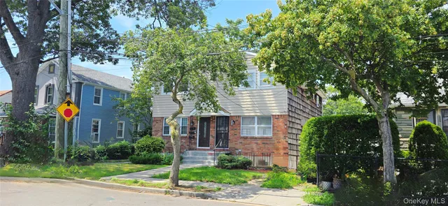 a front view of a house with a garden