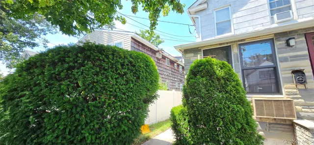 a view of a house with a tree front