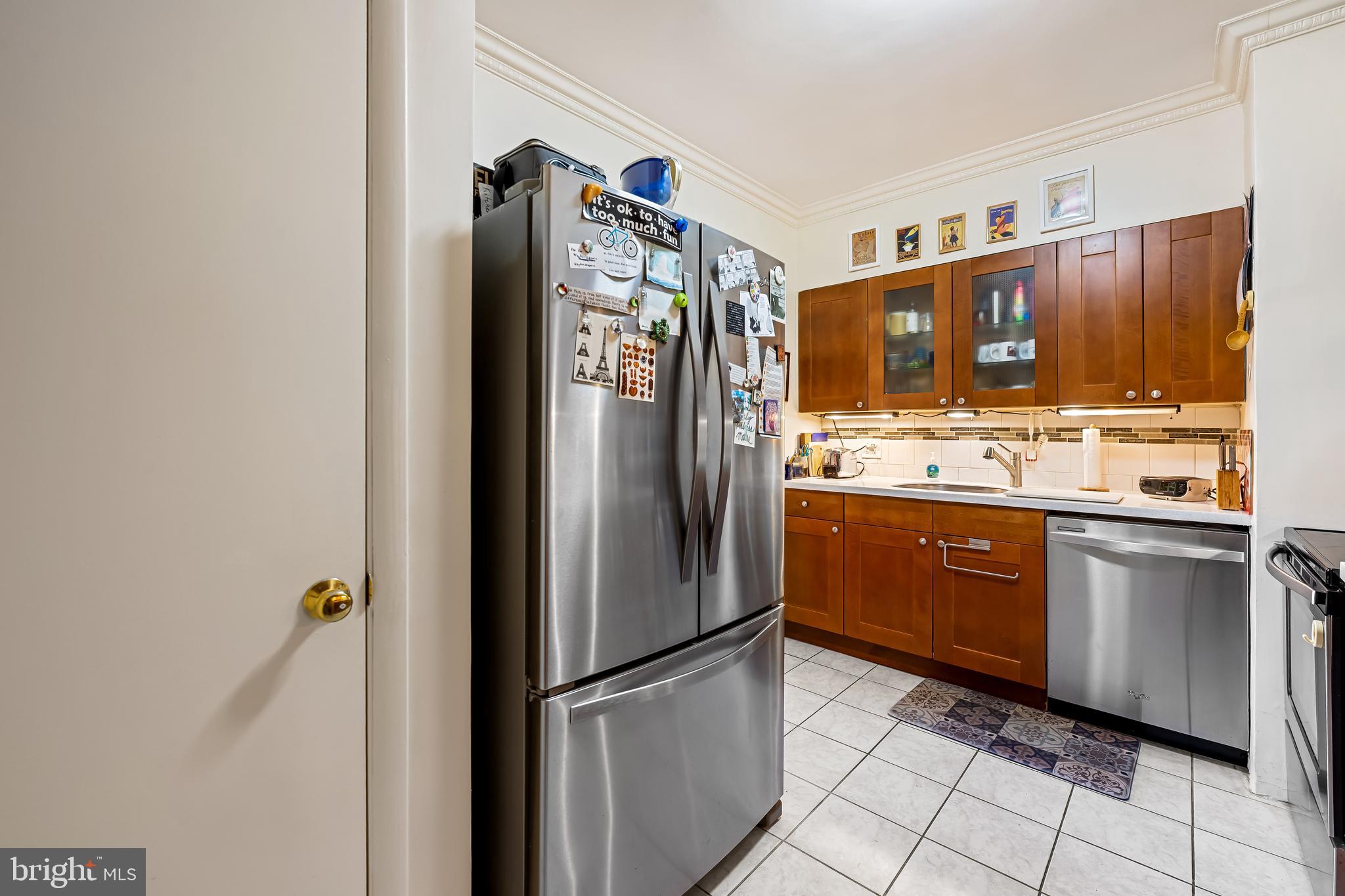 3601 Greenway, Unit 705 Baltimore, MD 21218 - Photo 13 of 30 a kitchen with stainless steel appliances granite countertop a refrigerator and a sink