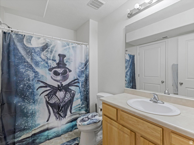 5038 West Red Shale Road Herriman, UT 84096 - Photo 11 of 16 Bathroom featuring a built-in wood-finish vanity with an integrated sink and chrome faucet