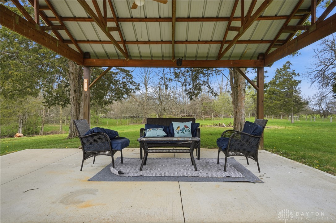 7553 Coffin Station Road Springfield, OH 45502 - Photo 19 of 95 This inviting outdoor space offers a peaceful retreat with ample room for relaxation and enjoying the natural surroundings.