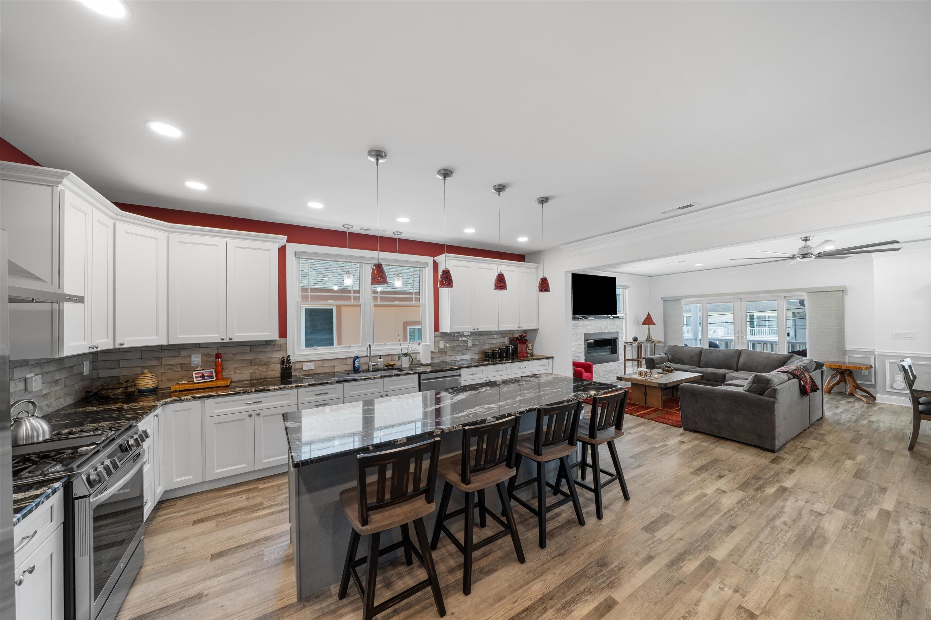 305 East Stockton Road Wildwood Crest, NJ 08260 - Photo 11 of 28 a kitchen with stainless steel appliances granite countertop wooden cabinets a stove a sink a dining table and chairs
