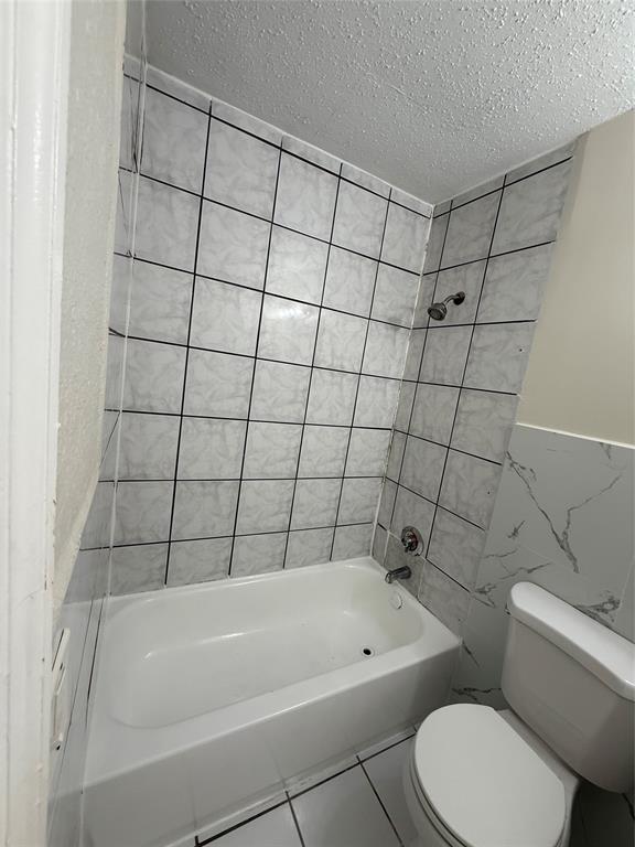 720 Southwest 7th Street, Unit 1 Dania Beach, FL 33004 - Photo 7 of 13 a bathroom with a bathtub and toilet