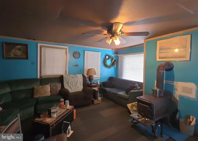 a living room with furniture a flat screen tv and a window