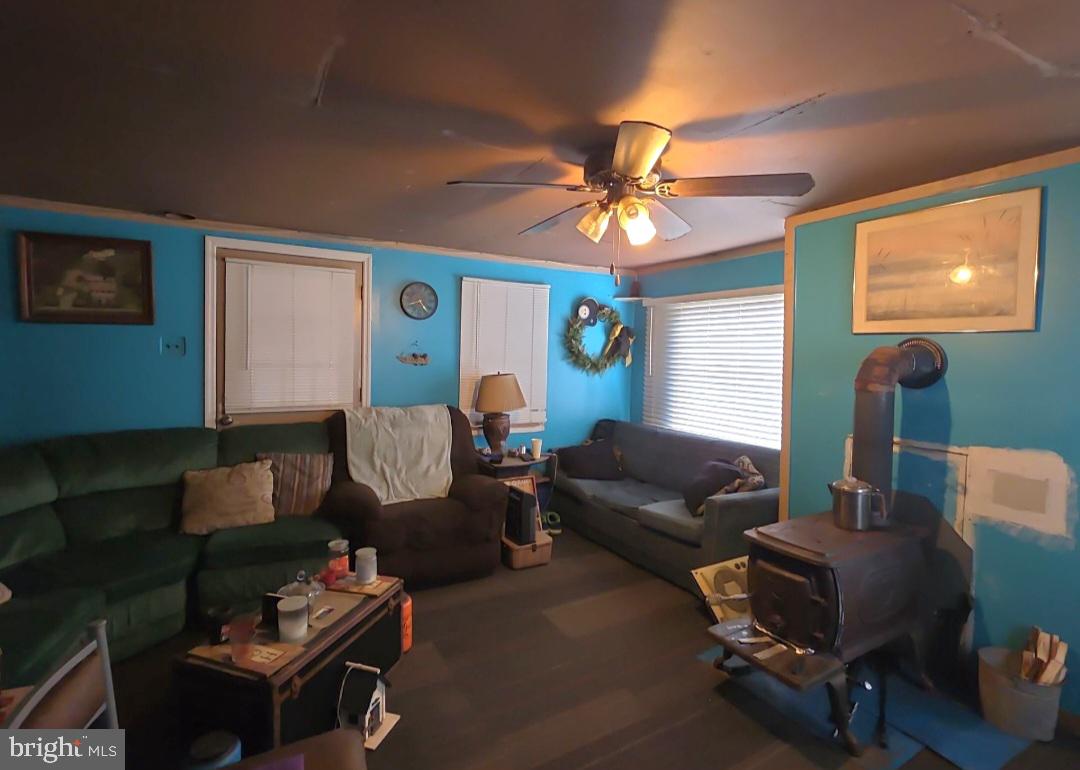 305 Main Street Newport, NJ 08345 - Photo 14 of 26 a living room with furniture a flat screen tv and a window