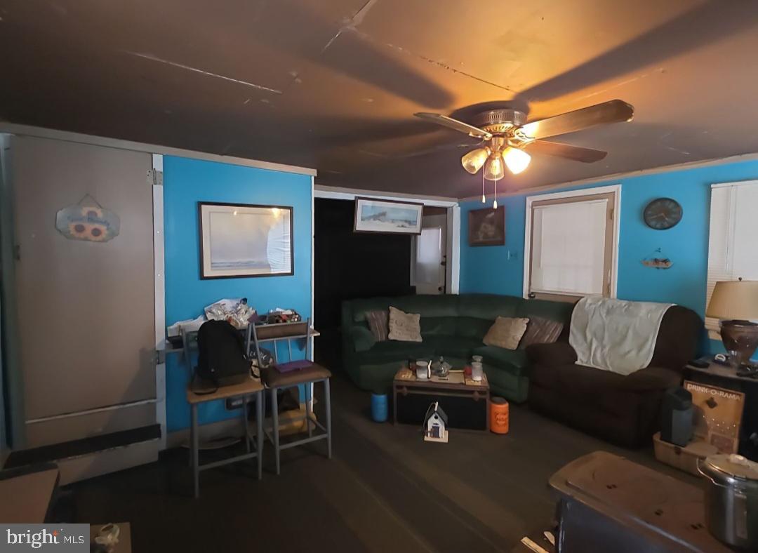 305 Main Street Newport, NJ 08345 - Photo 16 of 26 a living room with furniture and a flat screen tv