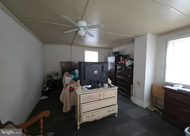 a room with furniture and a ceiling fan