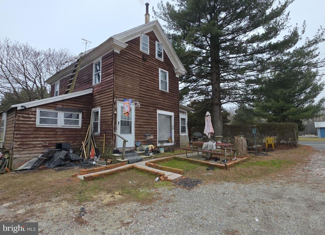 305 Main Street Newport, NJ 08345 - Photo 6 of 26 a backyard of a house with barbeque oven and outdoor seating