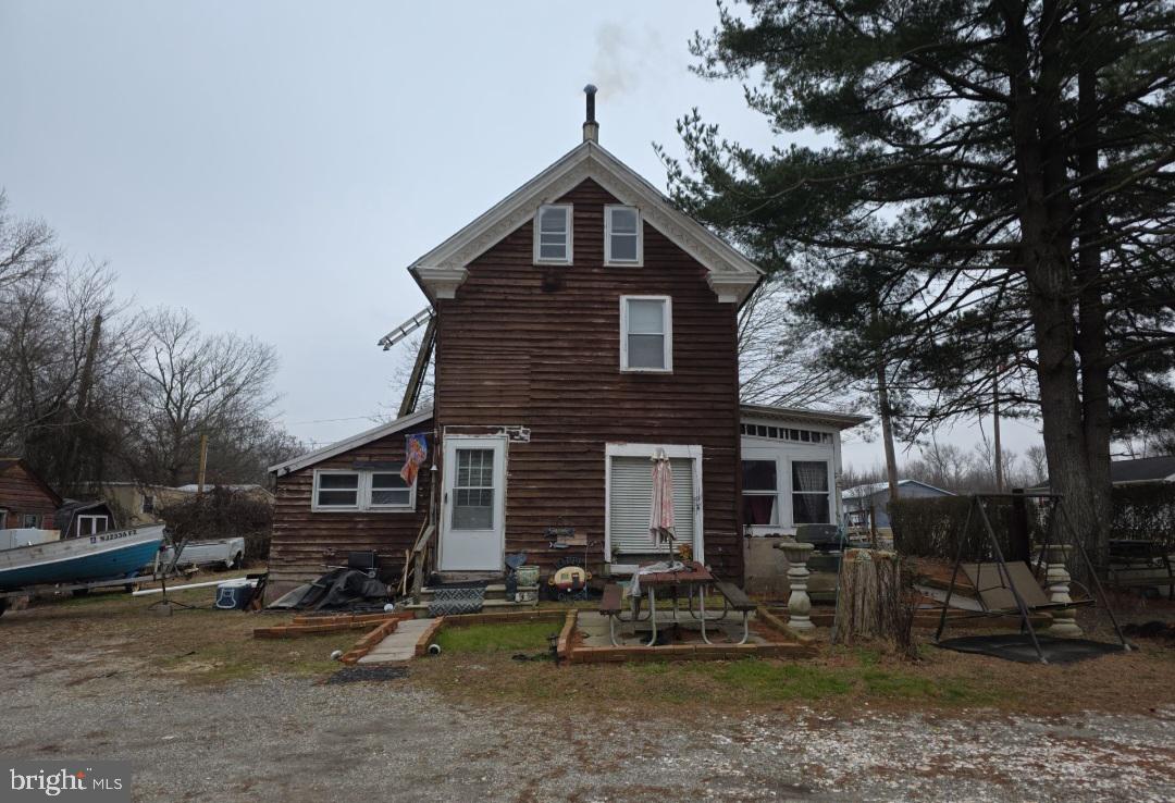 305 Main Street Newport, NJ 08345 - Photo 7 of 26 a front view of a house with patio