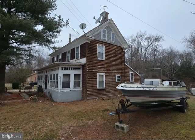 a view of a house with a balcony and sitting area