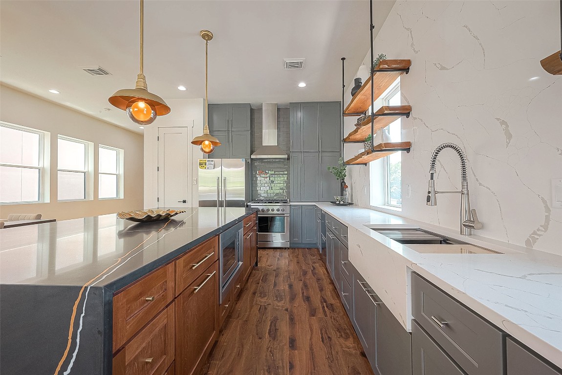 5510 Bosque Street Houston, TX 77056 - Photo 16 of 50 a kitchen with counter top space a sink appliances and windows