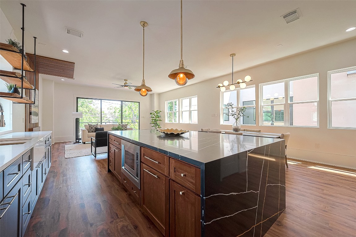 5510 Bosque Street Houston, TX 77056 - Photo 18 of 50 a kitchen with kitchen island granite countertop a stove a sink and a wooden floors