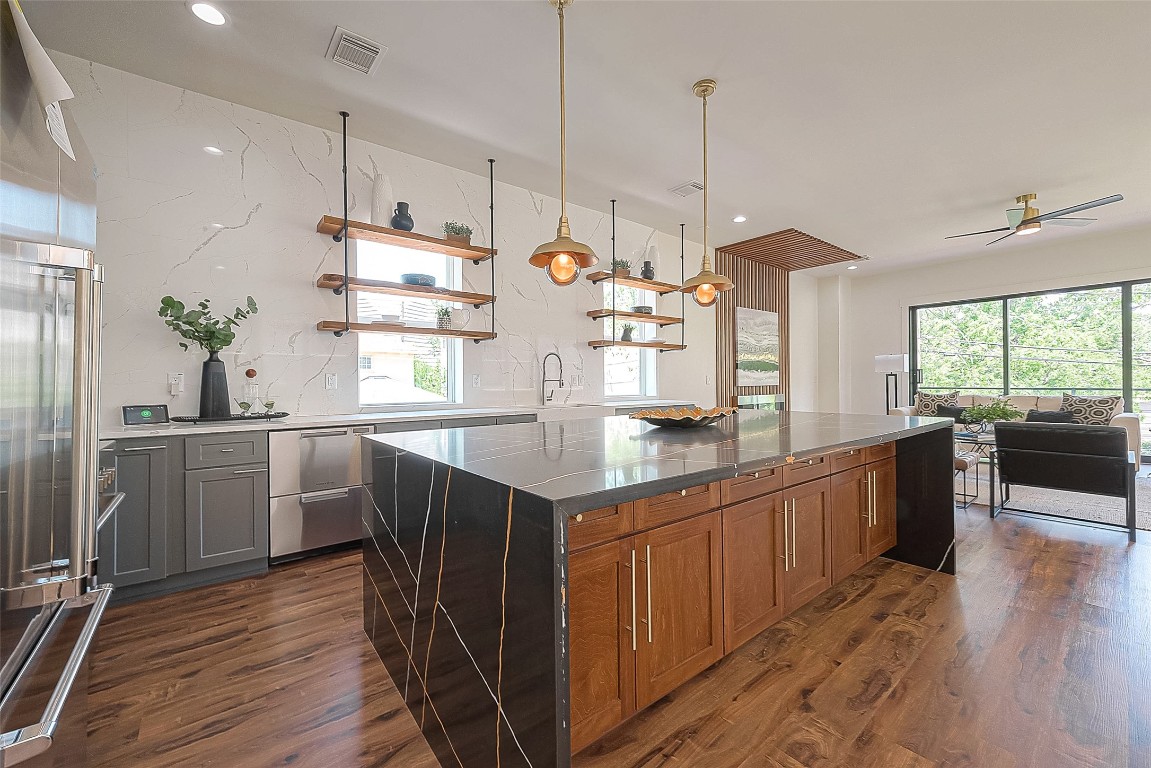 5510 Bosque Street Houston, TX 77056 - Photo 20 of 50 a kitchen with stainless steel appliances granite countertop wooden floors sink and cabinets