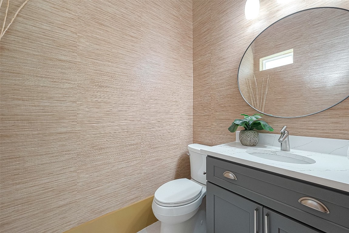 5510 Bosque Street Houston, TX 77056 - Photo 21 of 50 a bathroom with a granite countertop toilet a sink and mirror
