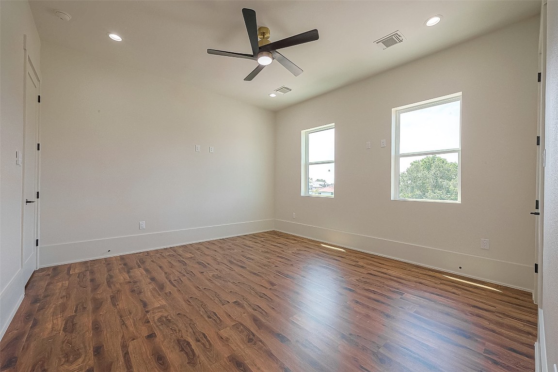 5510 Bosque Street Houston, TX 77056 - Photo 29 of 50 an empty room with wooden floor ceiling fan and windows