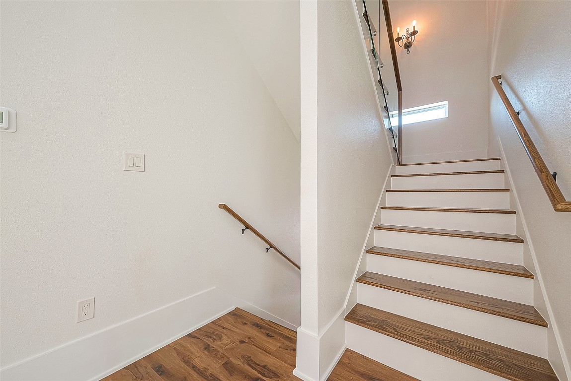 5510 Bosque Street Houston, TX 77056 - Photo 35 of 50 a view of staircase with white walls and railing