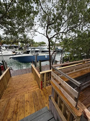 a balcony with wooden floor and city view