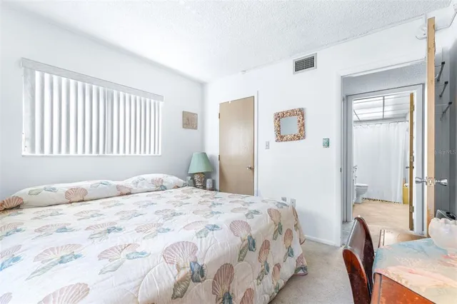 a bathroom with a granite countertop sink a toilet and a mirror