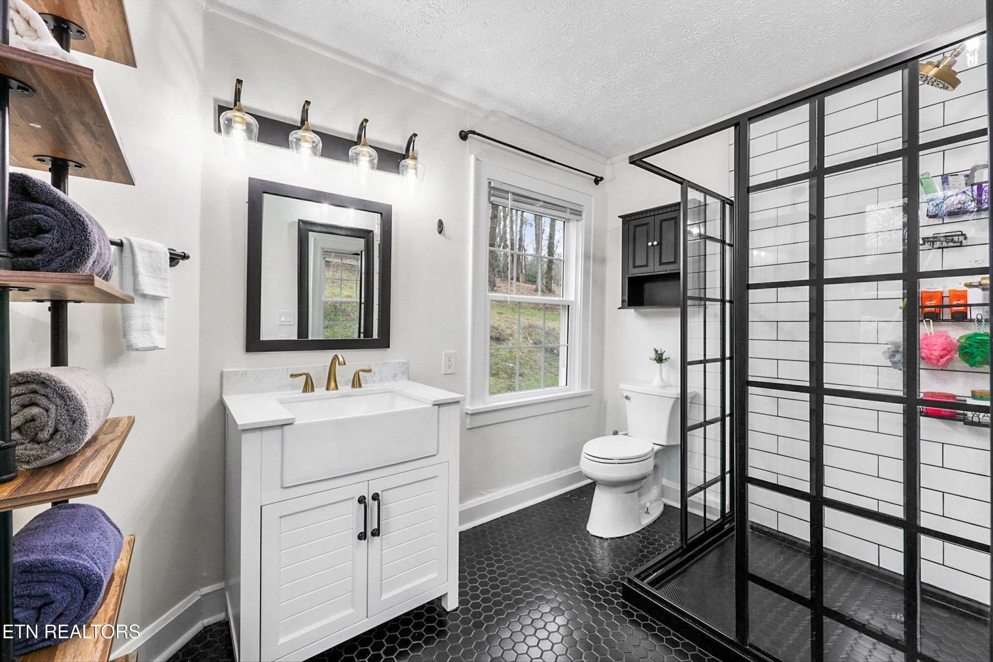 183 Laurel Road Clinton, TN 37716 - Photo 16 of 60 a bathroom with a toilet sink and mirror
