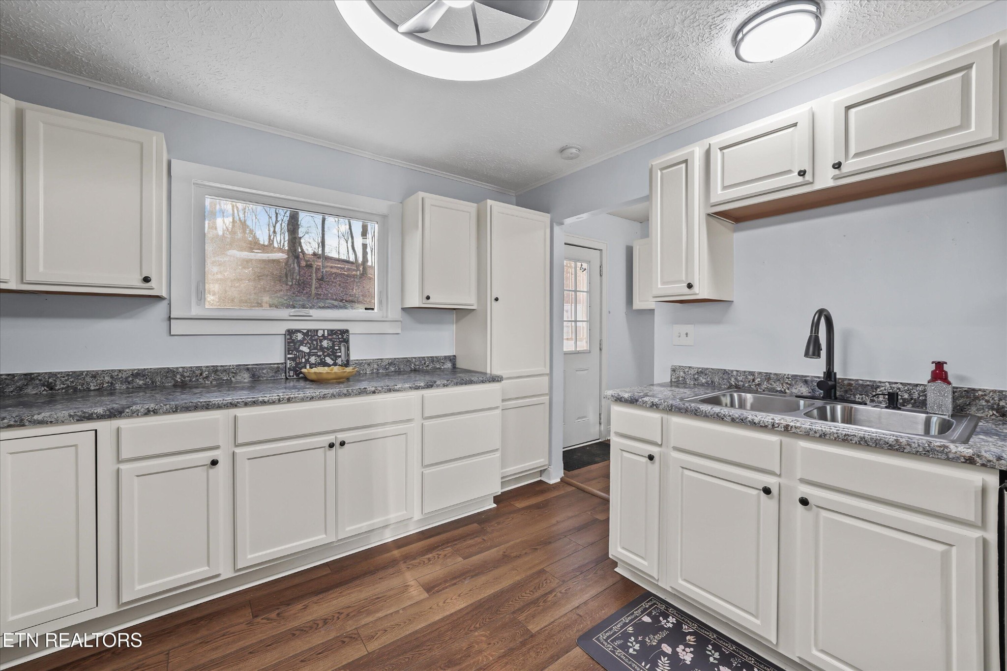 183 Laurel Road Clinton, TN 37716 - Photo 20 of 59 a kitchen with granite countertop white cabinets and white appliances