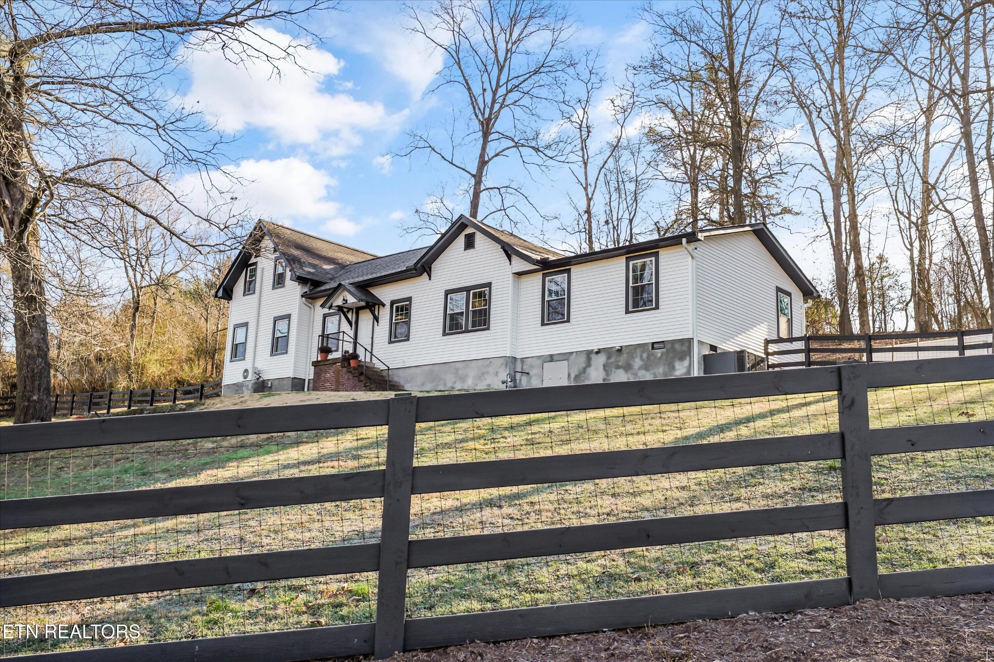 183 Laurel Road Clinton, TN 37716 - Photo 6 of 60 a view of a house with a small yard and a large tree