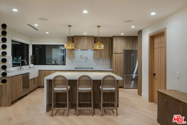 a kitchen with cabinets and chairs in it